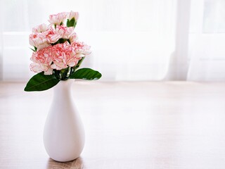 Pink white pastel Dianthus Carnation flowers in vase on table, Clove pink ,still life for background or wallpaper for text letter ,mother's day ,women's day ,soft color romantic love tone ,copy space 