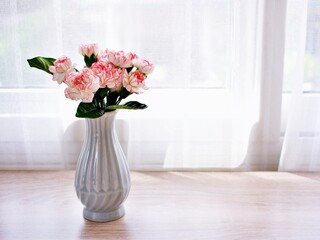 Pink white pastel Dianthus Carnation flowers in vase on table, Clove pink ,still life for background or wallpaper for text letter ,mother's day ,women's day ,soft color romantic love tone ,copy space 