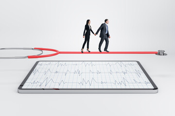 Young european businessman and woman walking on stethoscope above tablet with cardiology screen on light background. Medicine and doctor, healthcare concept.