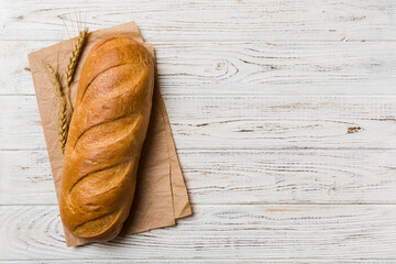 freshly baked bread with napkin on rustic table top view. Healthy white bread loaf isolated