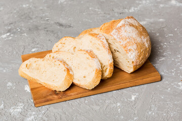 Assortment of freshly sliced baked bread with napkin on rustic table top view. Healthy unleavened bread. French bread slice