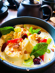 Healthy dessert with yogurt, nuts, mint, oats and blueberries