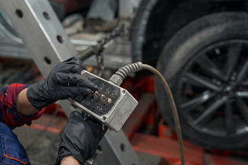 Auto mechanic using diagnostic equipment in care repair garage