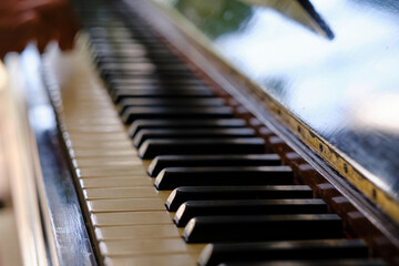 Close up of old piano keys and wood grains with sepia tone
