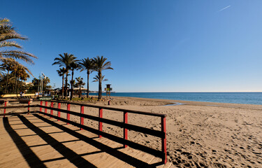 Promenade and palm trees on a beach of the Mediterranean Sea, on the Costa del Sol
