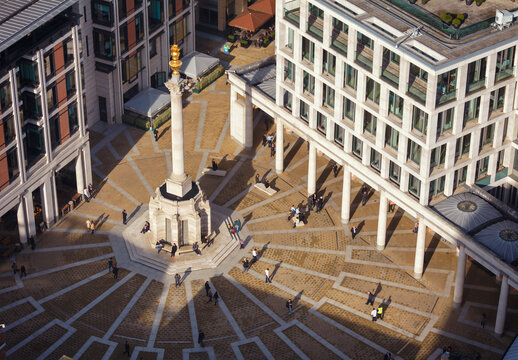 LONDON, UK - OCTOBER 30, 2012: Pedestrians crossing the Paternoster Square next to St Paul's Cathedral and London stock exchange (LSE) in the City of London