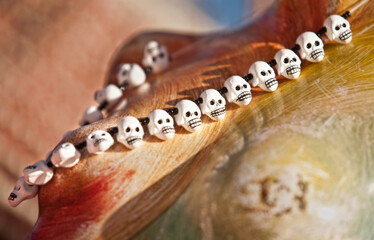 necklace with skulls on colours background