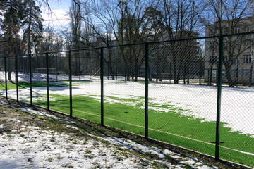 School soccer field covered with snow in winter