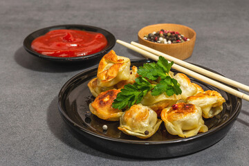 Deep-fried dumplings with tomato sauce and pepper mix. Vegan food, modern hard light, dark shadow