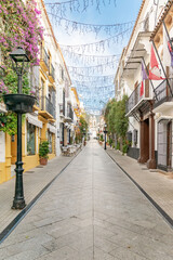 Obraz premium a view down the traditional Spanish streets in the old town center of Marbella 