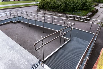 Fotobehang A ramp for people with disabilities near a public building. © Андрей Знаменский