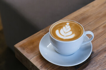 A cup of hot latte coffee on the table for breakfast
