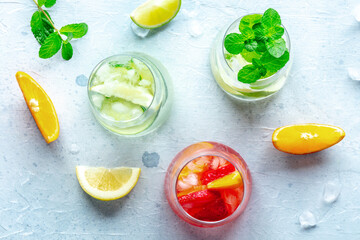 Fresh summer cocktails or mocktails with fruit and ice, a vacation party with strawberry, citrus and cucumber lemonades, healthy cold drinks