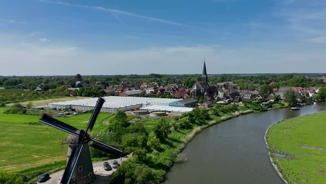 The Dutch town of Beesd from the air with its characteristic stubby tower and windmill De Vrijheid