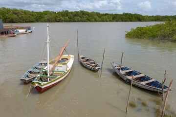 Fototapeta na wymiar Fishing boats moored in a river, isolated in Alcântara, Maranhã, Brazil.