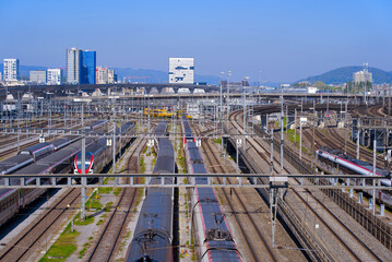Fototapeta premium Track field with parked trains at railway station Hard Bridge at City of Zürich on a sunny spring day. Photo taken April 28th, 2022, Zurich, Switzerland.