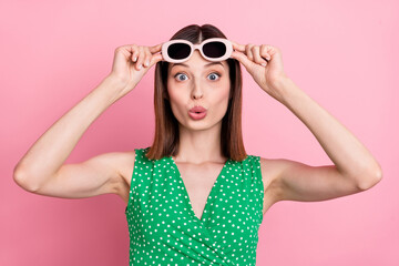Photo of young woman impressed look see hands touch eyeglasses reaction isolated over pink color background
