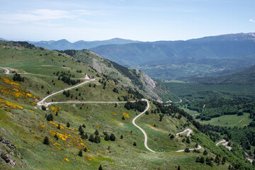 View of a mountain road on a sunny day at the Col de Pailheres, France.