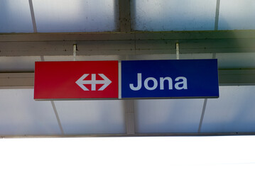 Sign at railway station of City of Jona on a sunny spring day. Photo taken April 28th, 2022, Rapperswil-Jona, Switzerland.