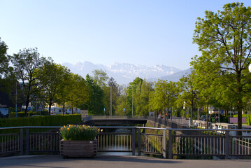 Panoramic view of the Swiss Alps with Jona River in the foreground seen from City of Jona, Canton St. Gallen, on a sunny spring day. Photo taken April 28th, 2022, Rapperswil-Jona, Switzerland.