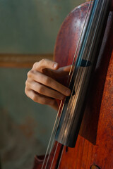 Woman's hand playing pizzicato on the cello