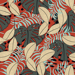 Original seamless tropical pattern with bright plants and leaves on a red background. Colorful stylish floral. Trendy summer Hawaii print. Beautiful exotic plants. Hawaiian style.