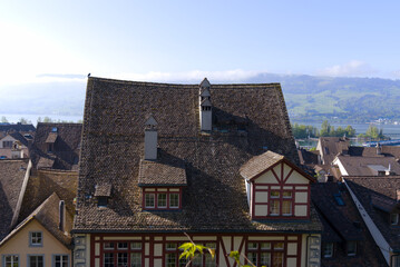Fototapeta na wymiar Aerial view of the old town of City of Rapperswil with Swiss Alps in the background on a sunny spring day. Photo taken April 28th, 2022, Rapperswil-Jona, Switzerland.