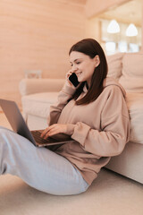 Woman working remotely from her house with a laptop