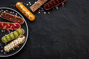 Group of decorated eclairs with pistachio raspberries and chocolate