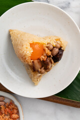 Zongzi. Rice dumpling for Dragon Boat Festival on bright marble table background with ingredient.