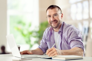 Busy Young Businessman Using Computer in Modern Office. Manager Thinks About Successful Financial Ideas.