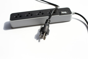 Electrical power strip and plug on white background.