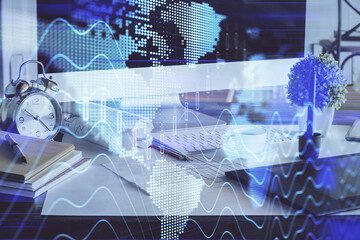 Forex market graph hologram and personal computer on background. Multi exposure. Concept of investment.