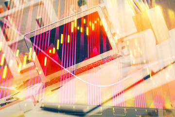 Obraz premium Forex market graph hologram and personal computer on background. Multi exposure. Concept of investment.