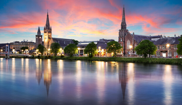 The view of the churches of Inverness on the Ness River, Scotland, UK at dramatic sunrise with reflection in water