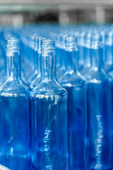 Many empty bottles at beverage factory. Alcohol beverage production