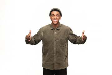 Handsome latin man posing over white background gesturing with hands and showing big and large size sign, measure symbol. Looking at the camera with smile. Measuring concept