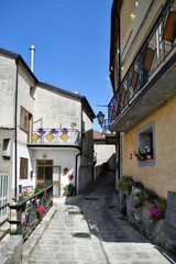 A narrow street between the old houses of Marsicovetere, a village in the mountains of Basilicata, Italy.