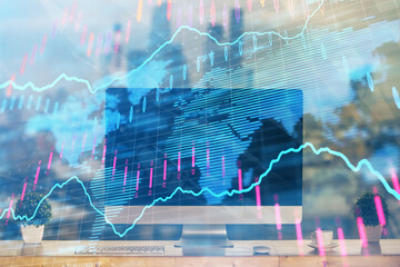 Forex market graph hologram and personal computer on background. Multi exposure. Concept of...