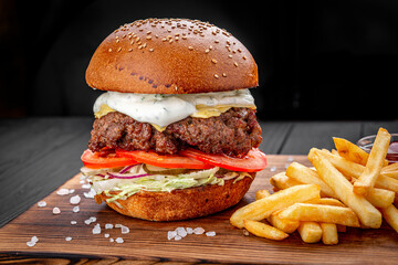 An american burger with fried potatoes