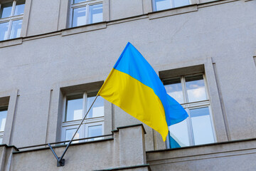 Flag of Ukraine on the background of the house, national flag, state symbol.