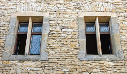 A windows with decorative glass in the facade of a historic building.