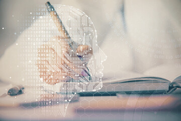 Double exposure of woman's writing hand on background with brain hologram. Concept of brainstorming.