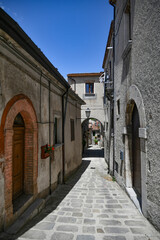 A narrow street between the old houses of Marsicovetere, a village in the mountains of Basilicata, Italy.