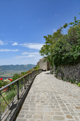 A narrow street between the old houses of Marsicovetere, a village in the mountains of Basilicata, Italy.