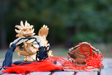 A dragon figurine with Chinese coins in its teeth. Next to the figure of a toad. A religious and esoteric symbol.