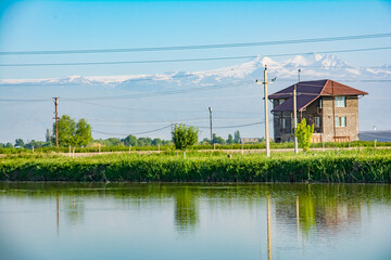 Lonely house by the lake. Small lake and residential building