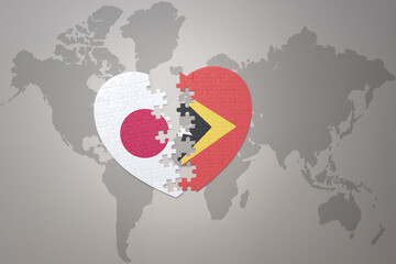 puzzle heart with the national flag of japan and east timor on a world map background. Concept. 3D illustration