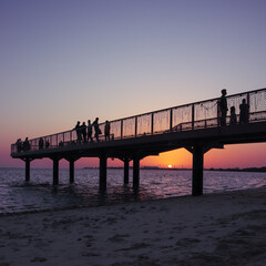 Fototapeta premium sunset view at the pier in abu dhabi island beach, UAE