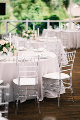 Wedding outdoor table serving. Wedding luxury decor. Wedding presidium for the newlyweds. Beautiful decor with pastel roses, candles and greenery.